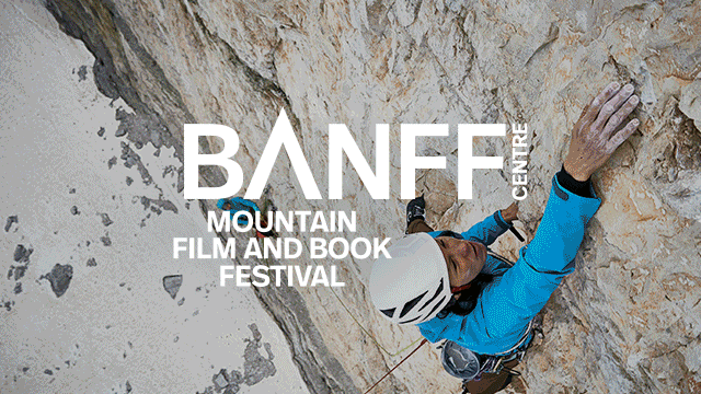 man climber on a steep wall with snow at the feet of the mountain