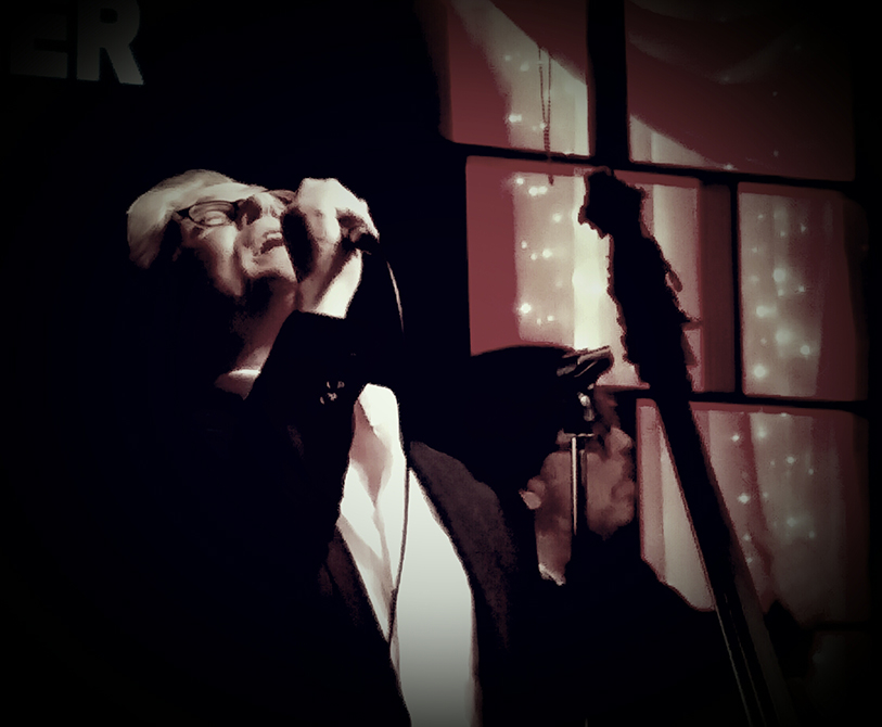 John Alcorn on the stage singing