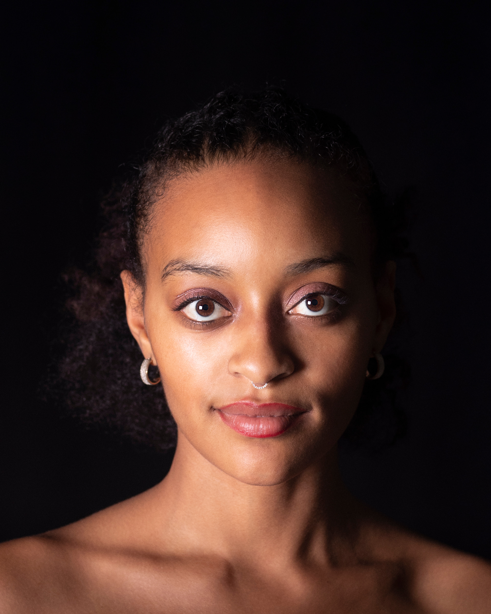 portrait of woman looking directly at camera smiling slightly