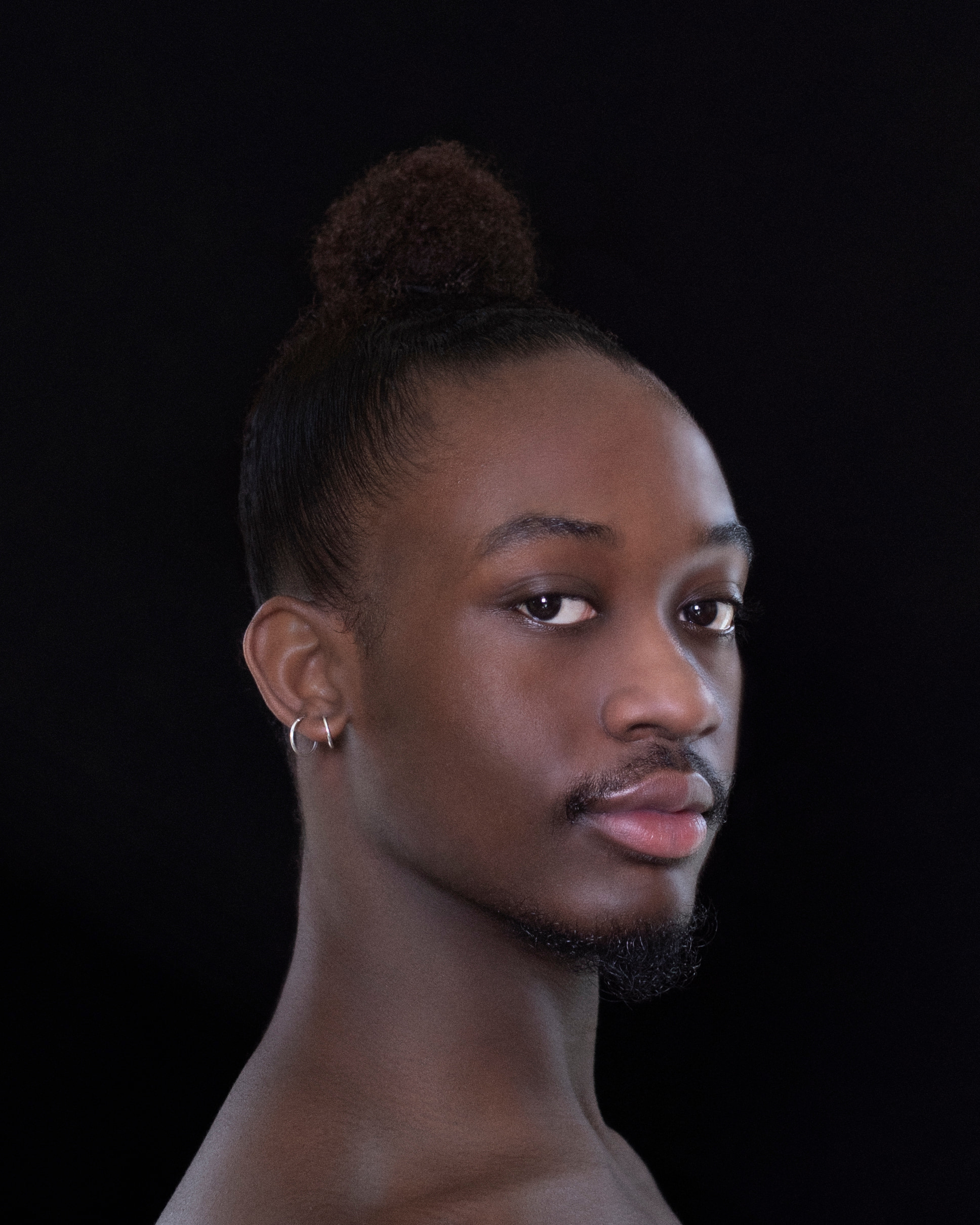 side portrait of dancer with head turned facing camera