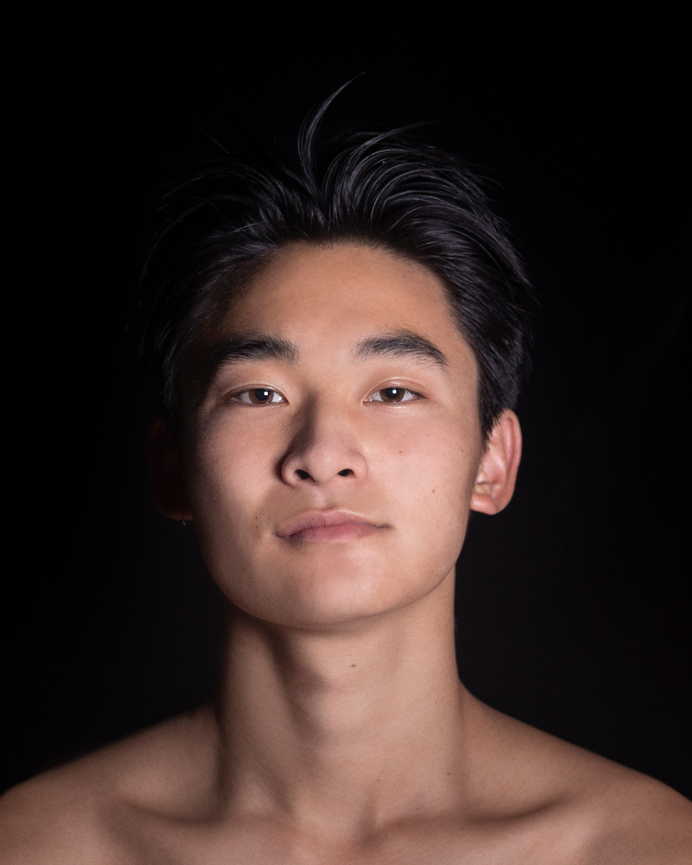 portrait of man from shoulders up smiling lightly and looking directly at camera
