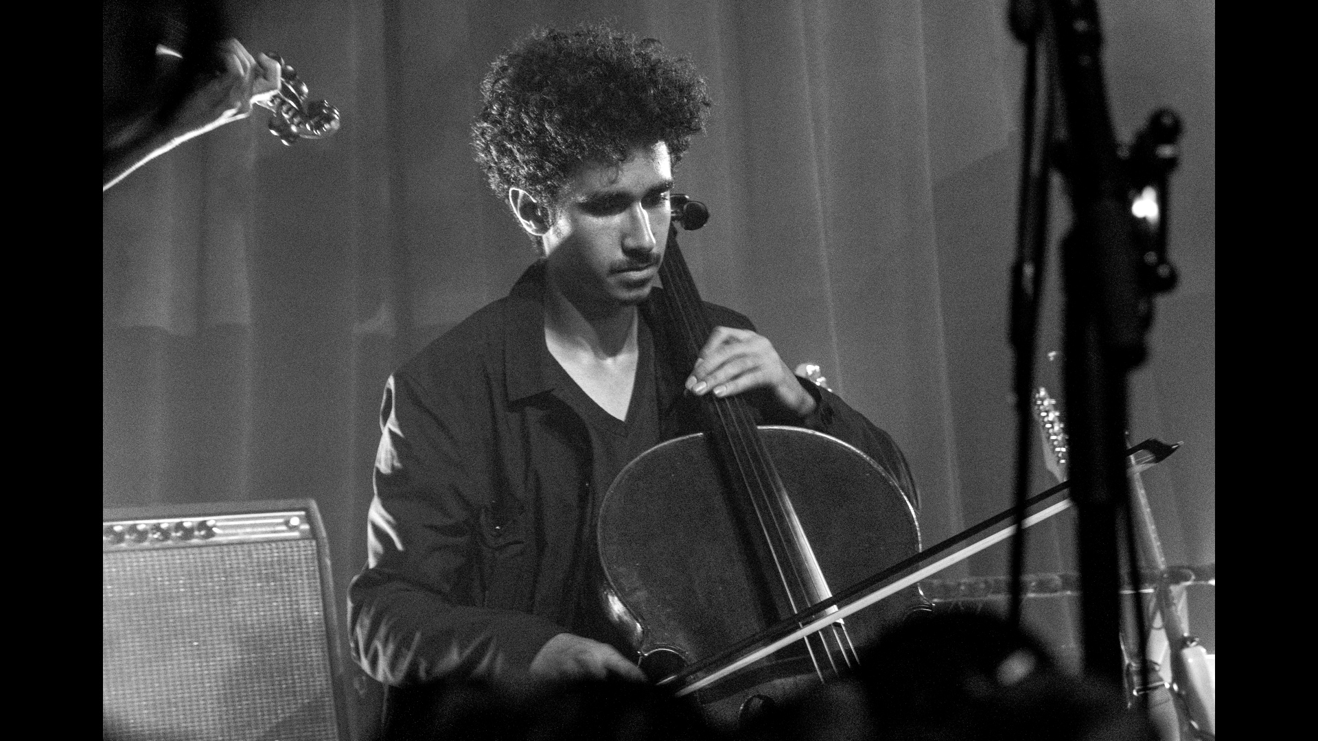 Black and White photo of man playing cello