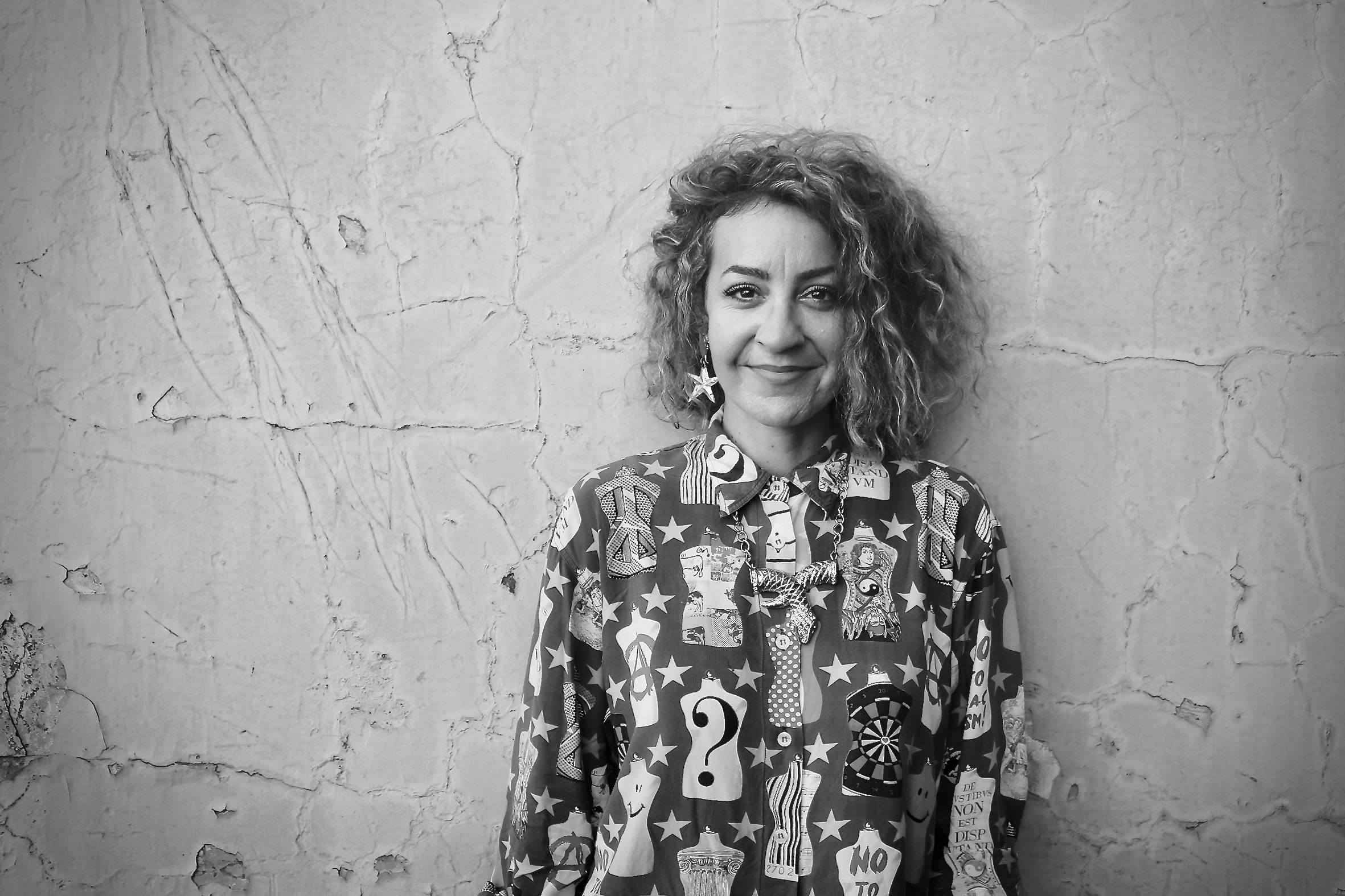 Women with curly hair and playful shirt
