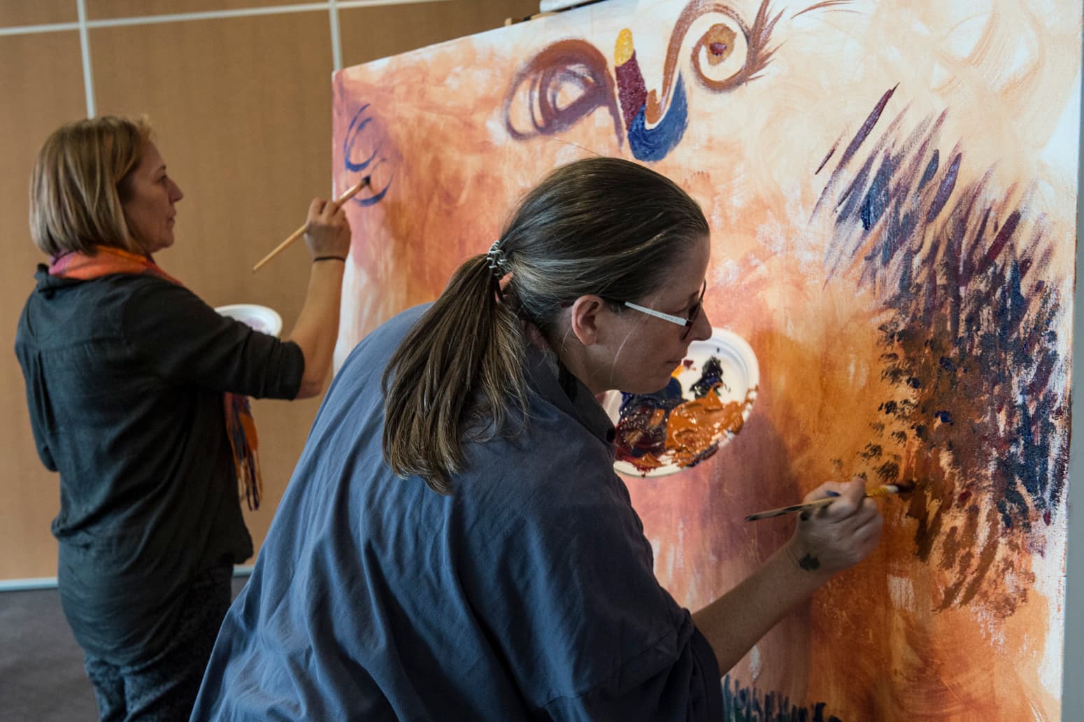 Participants painting an art piece