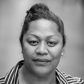 Black and white picture of a women smiling and with her hair up