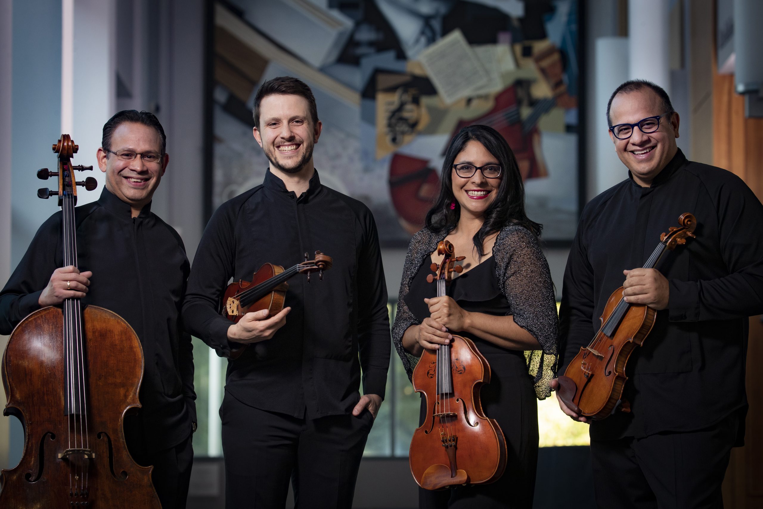 A string quartet pose with their instruments
