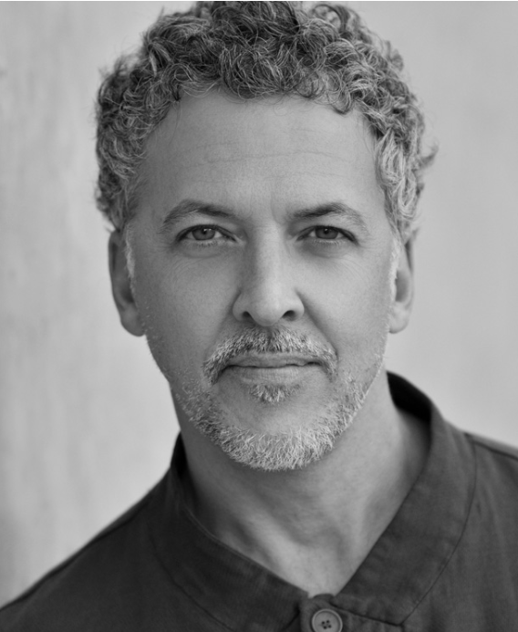 Men with curly short hair in a black shirt