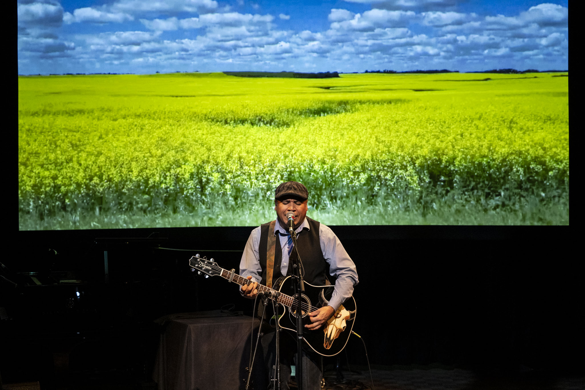 Dale Mac playing a guitar on stage
