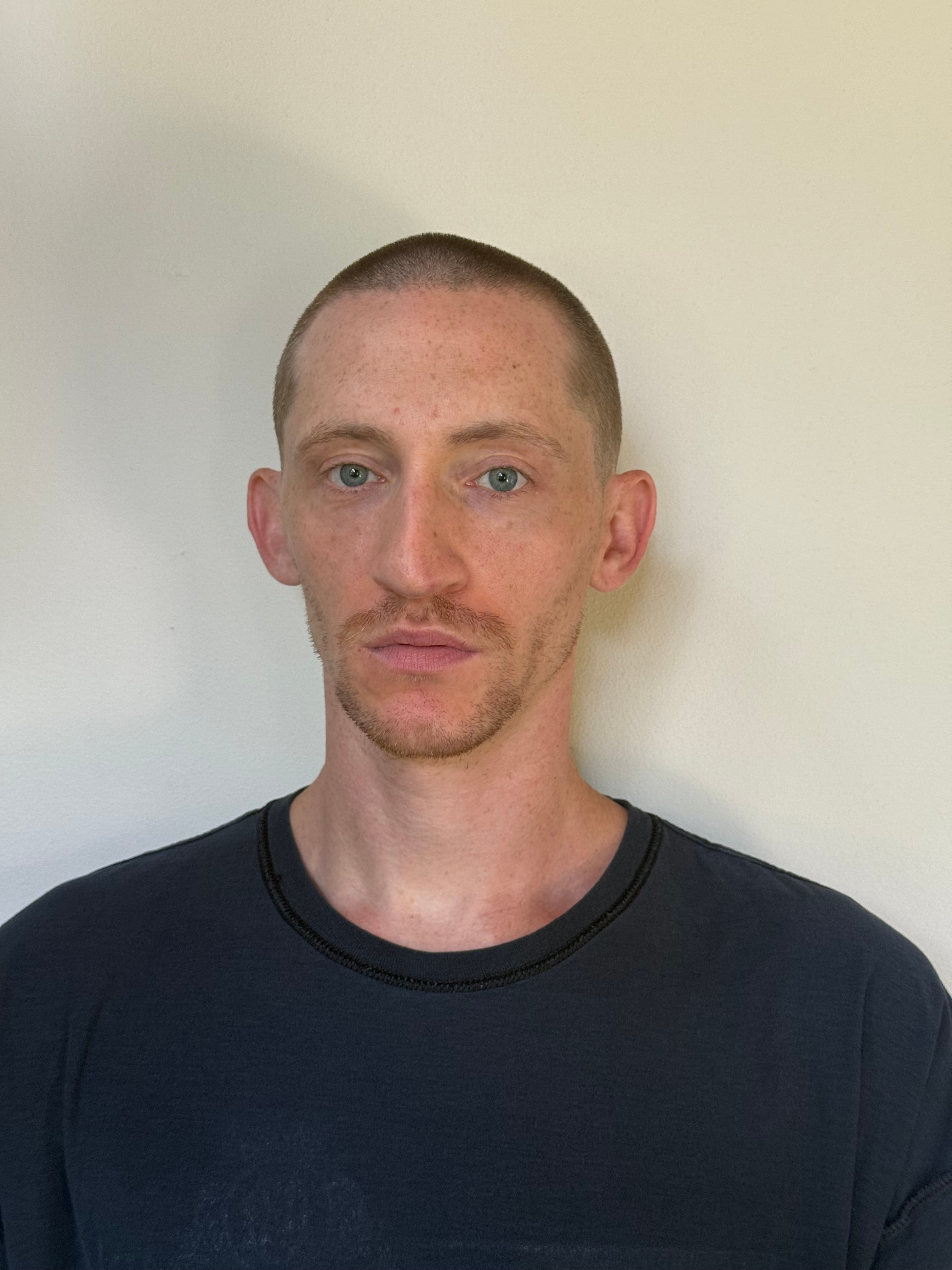 White male very thin and in black shirt