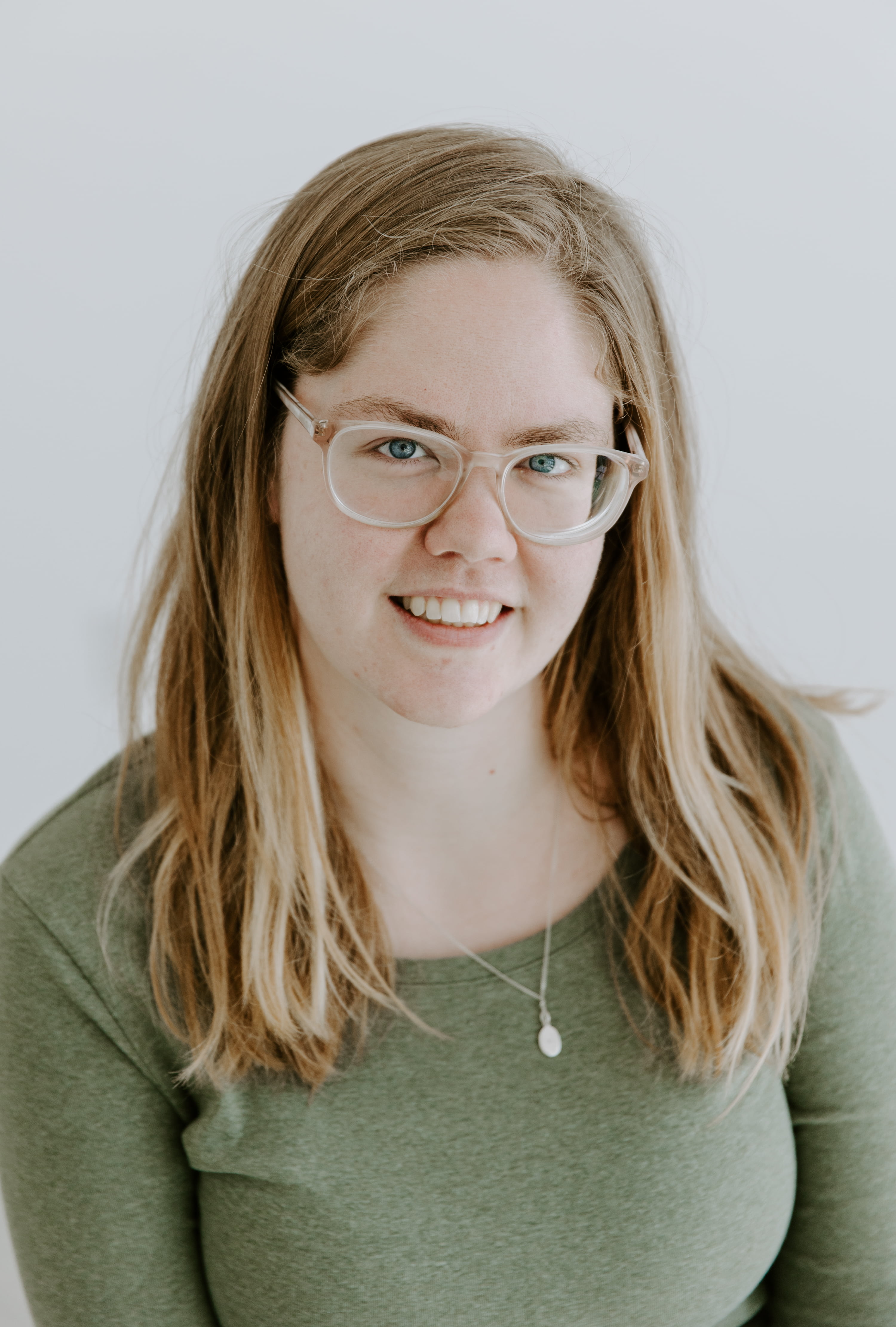 Woman with long blonde hair smiling at camera