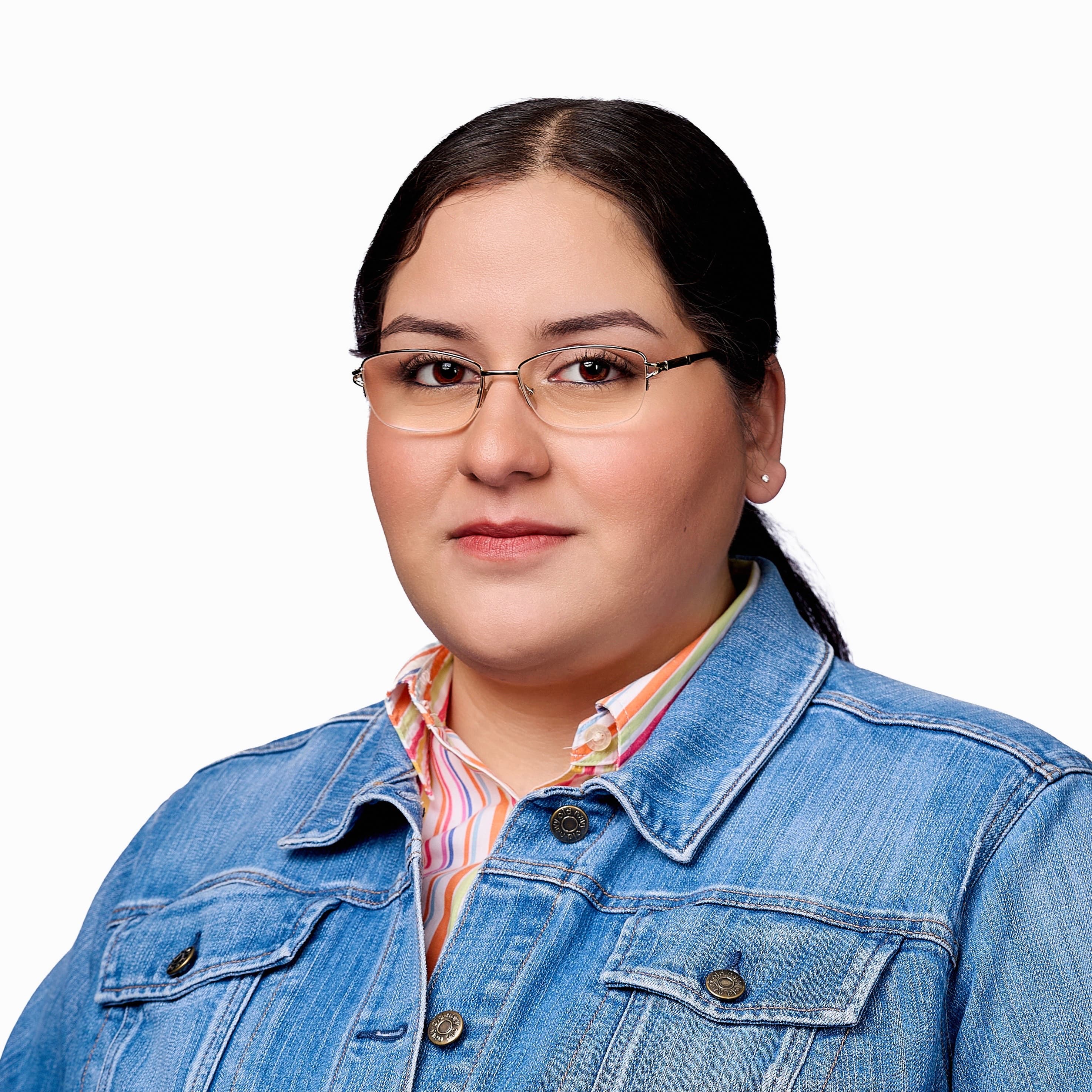 Women with long hair wearing glasses and jean jacket
