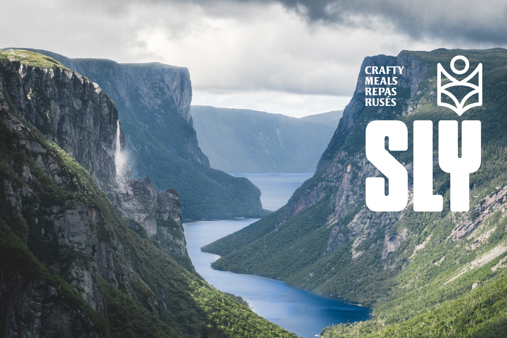 A fjord in on the Atlantic coast of Canada features forested coastline with cliffs hundreds of meters high. 