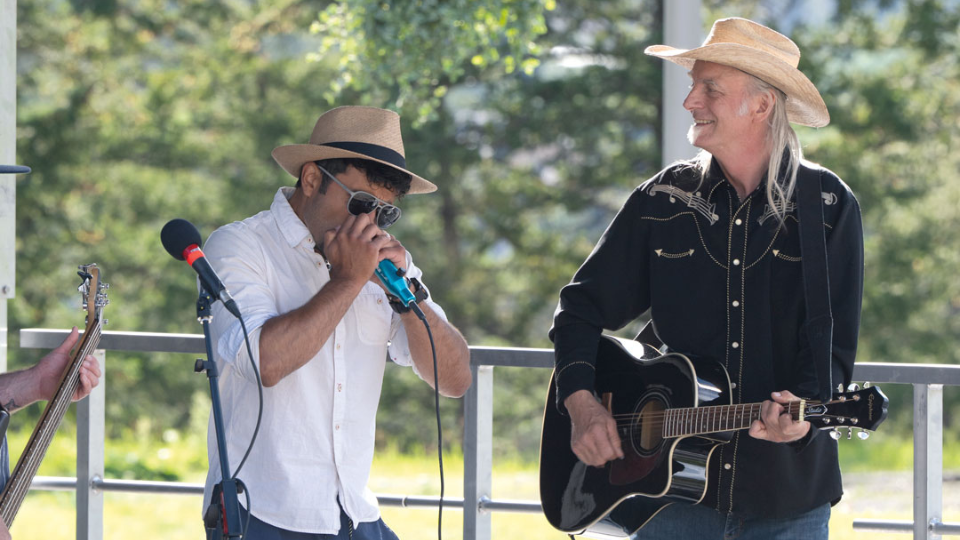 Music singer and guitarist playing outside on a warm and sunny day