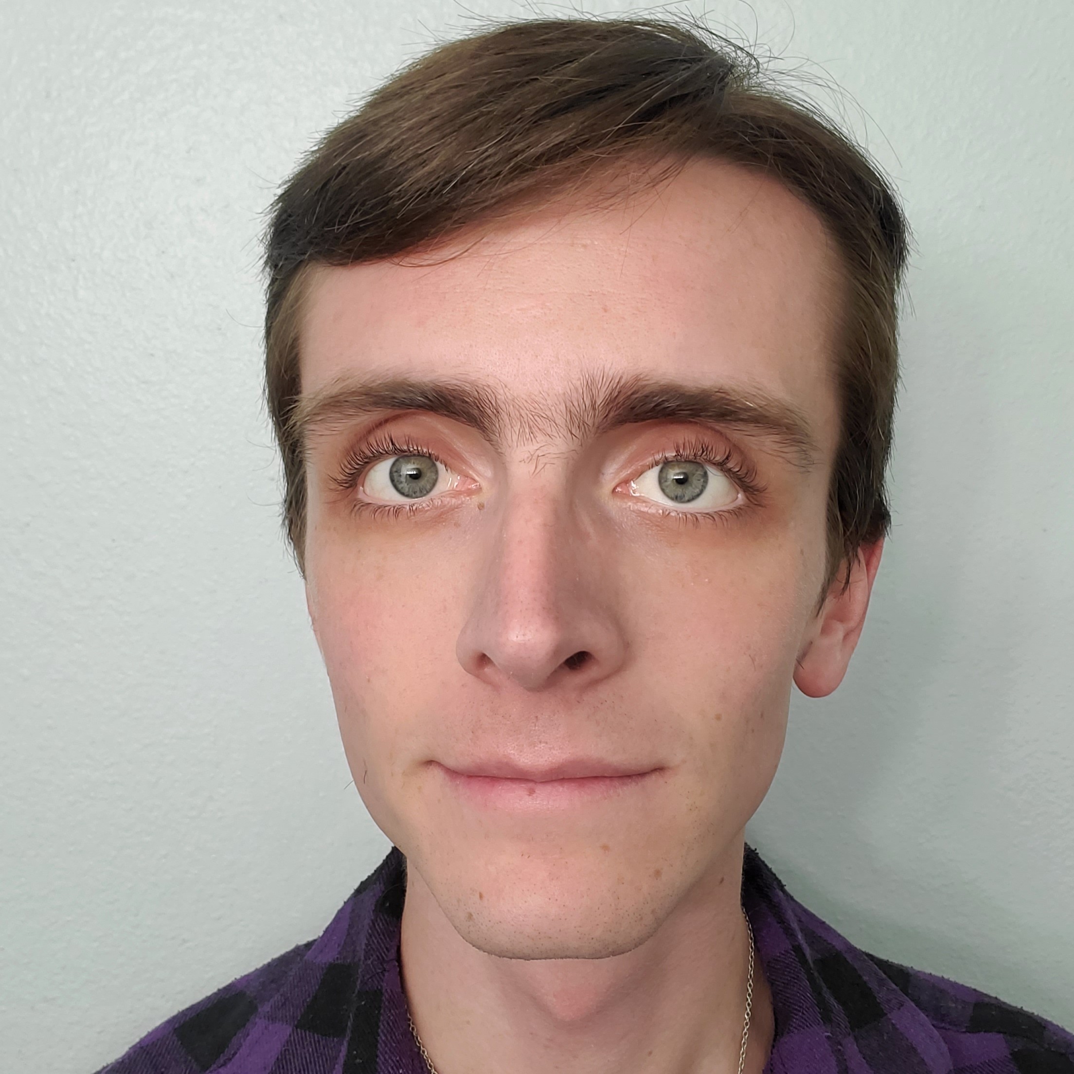 Close up of man looking straight at the camera with slight smile