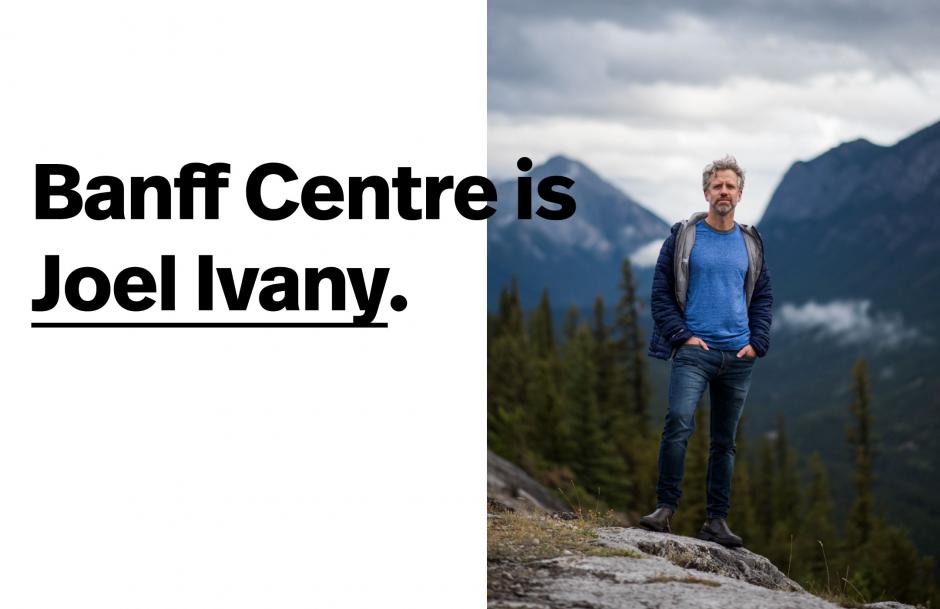 Image of Joel Ivany standing on top of a rock with a foggy mountain background. 