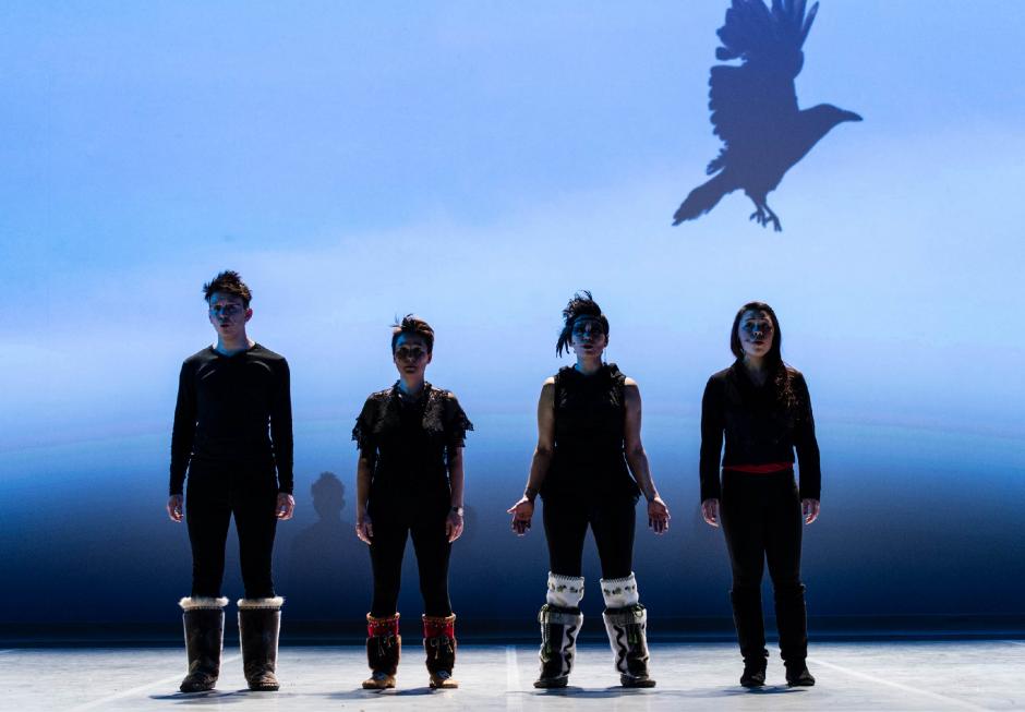 Four artists performing on a beautiful blue stage in a theatre. 