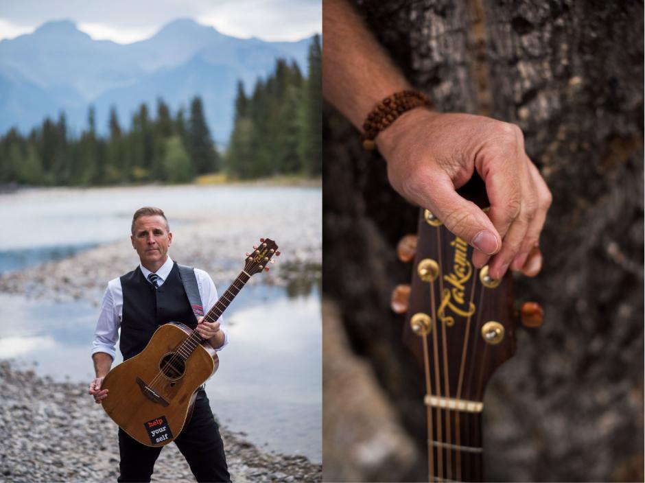 Sean McCann with his guitar alongside a river in the mountains. 