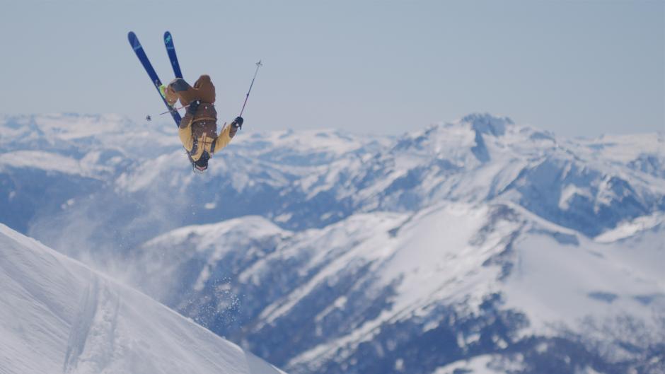 Wallmapu | Banff Centre Mountain Film and Book Festival Skiier performs a backflip with a mountain range in the background.