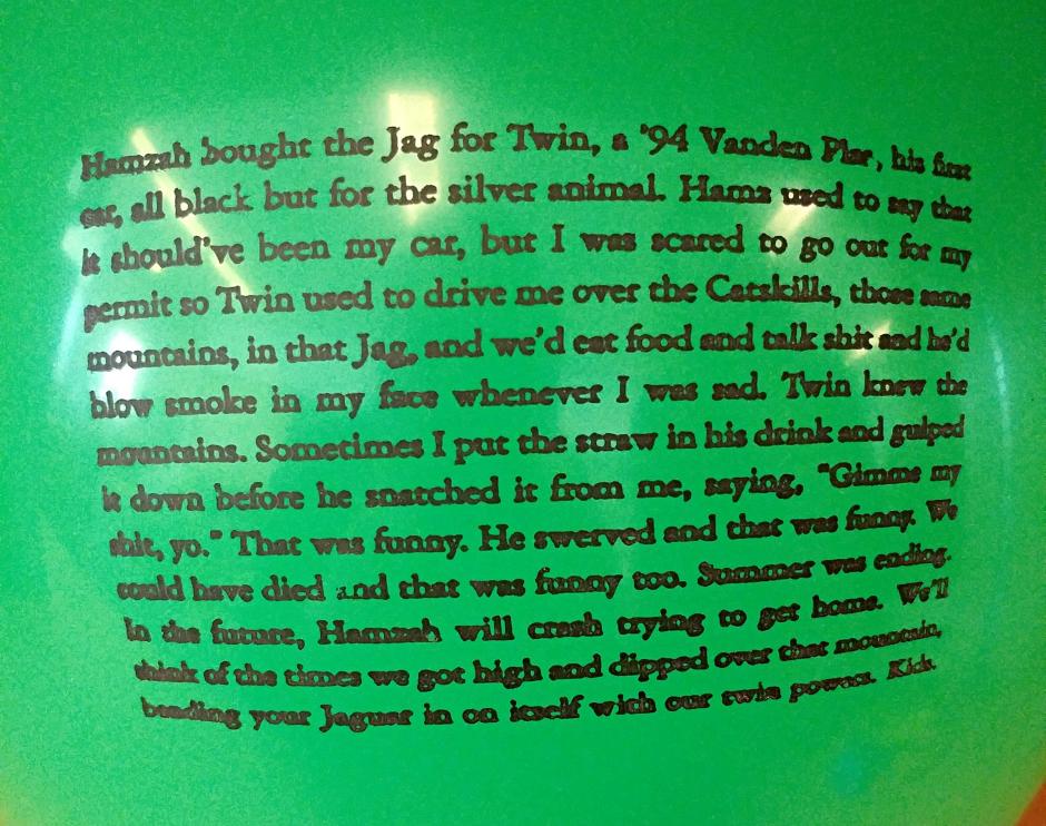 A green balloon with a short story printed on it. 