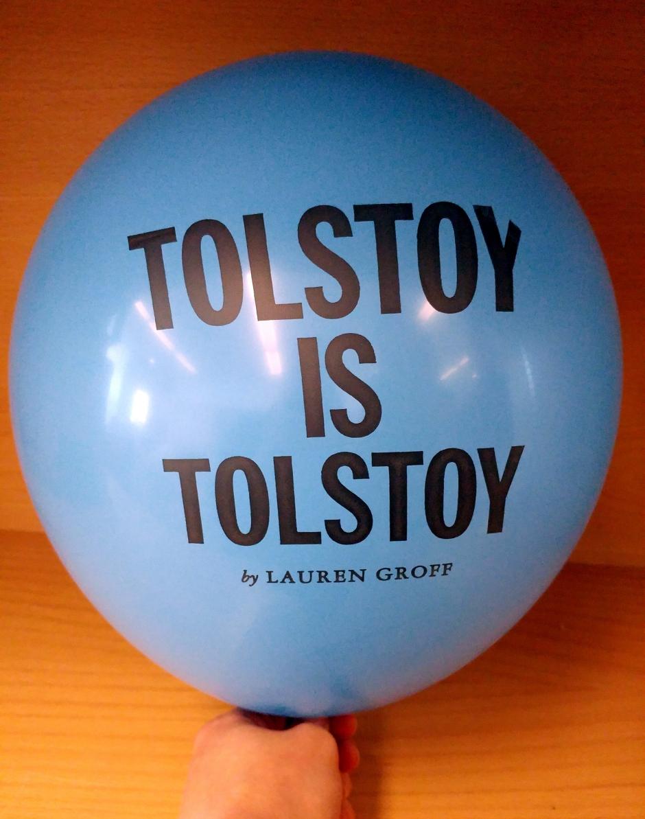 A blue balloon inflated with the text, "Tolstoy is Tolstoy by Lauren Groff," printed on it. 