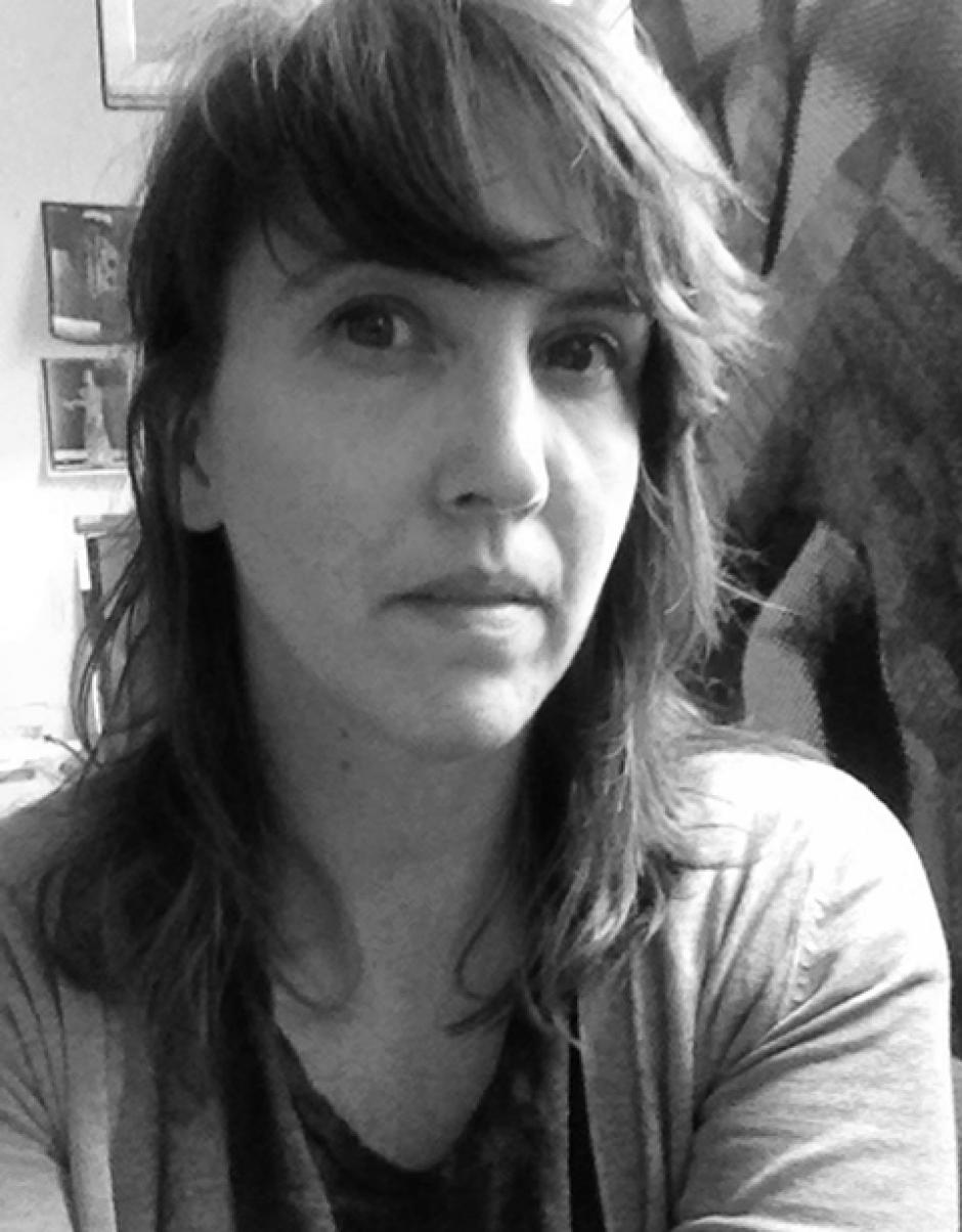 Artist Shannon Bool stares at the camera close-up in a grey-scale photo.