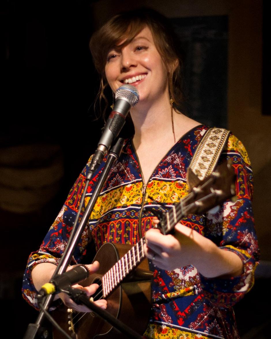Heather Jean Jordan performing live with a guitar