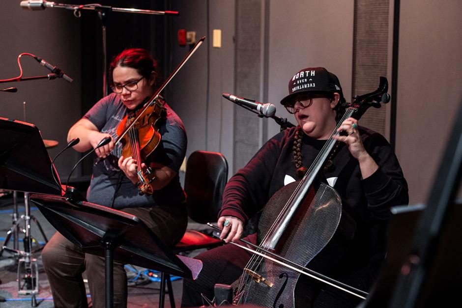 Two musicians performing with string instruments