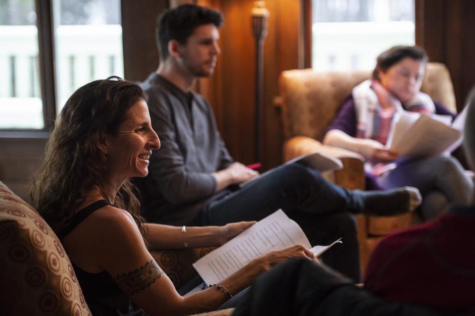 Writers sitting in a studio with open books.  