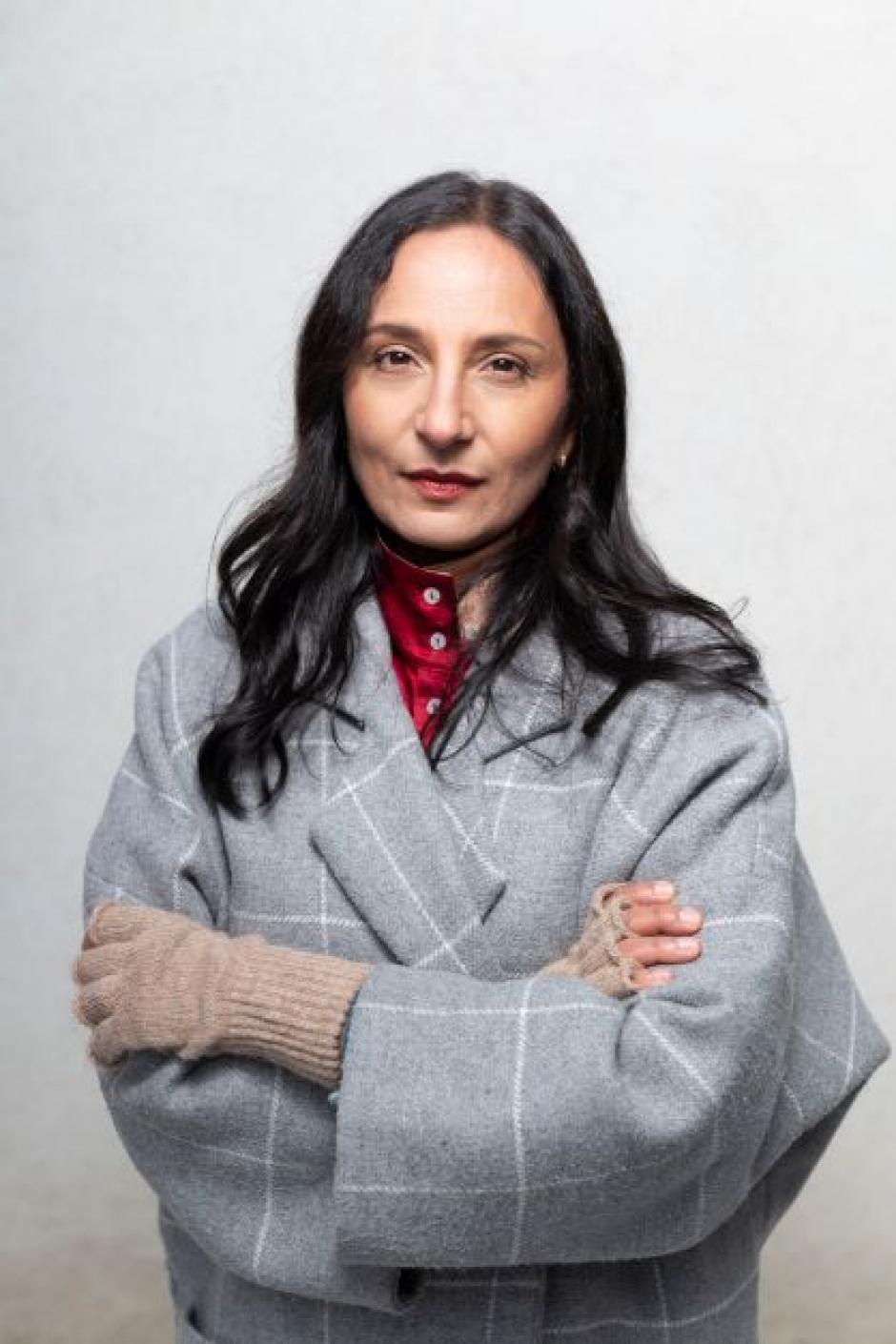Photo of program faculty, Madhur Anand, looking at the camera with arms folded