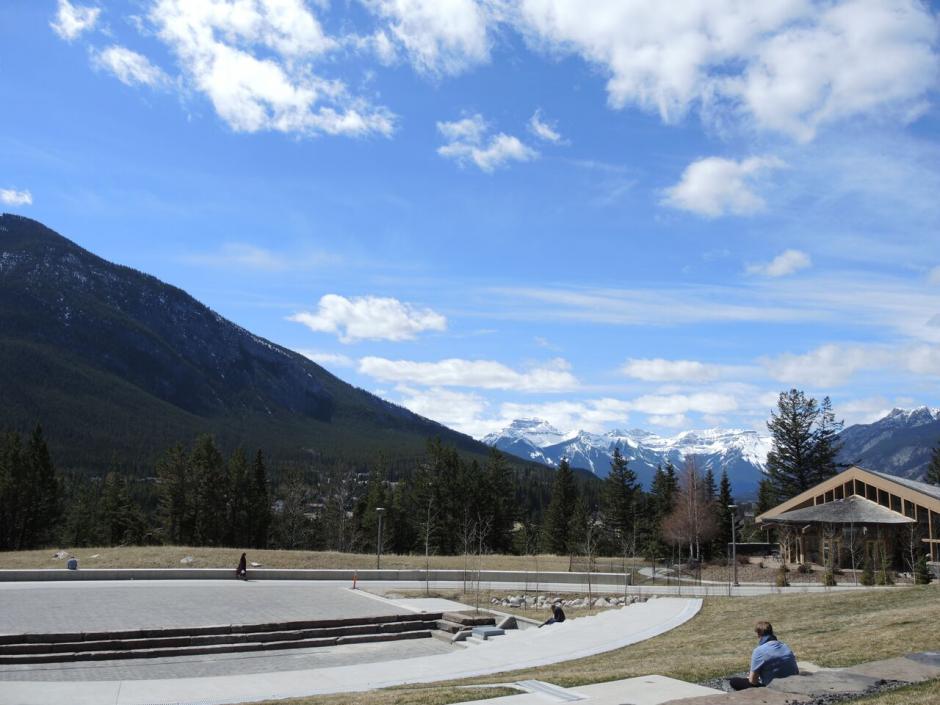 Phyllis Novak takes time to reflect looking at the Bourgeau mountain range. View from the amphitheatre at The Banff Centre