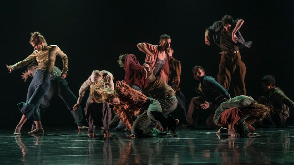 Dance Programs | Banff Centre Dancers performing on a dark stage.
