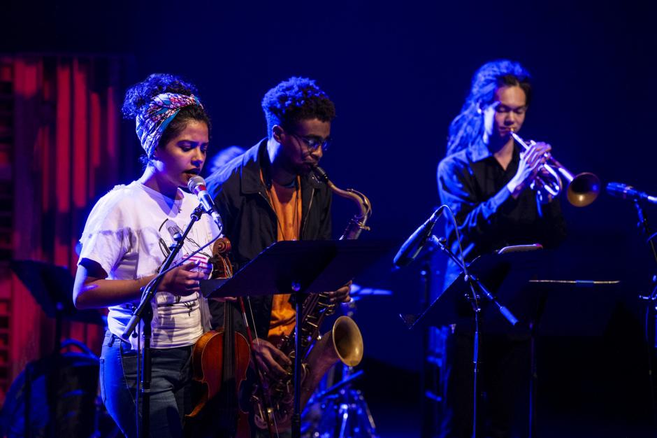 Three Musicians jam in darkened club Three Musicians jam in darkened club