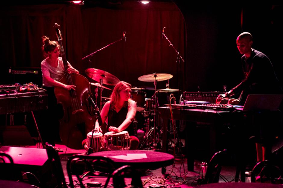 Jazz Club Convergence, 2018. Krissy Bergmark, tabla; Adi Meyerson, bas; and Val Jeanty, turn-tables, wave drum. Jazz musicians performing on a dark stage