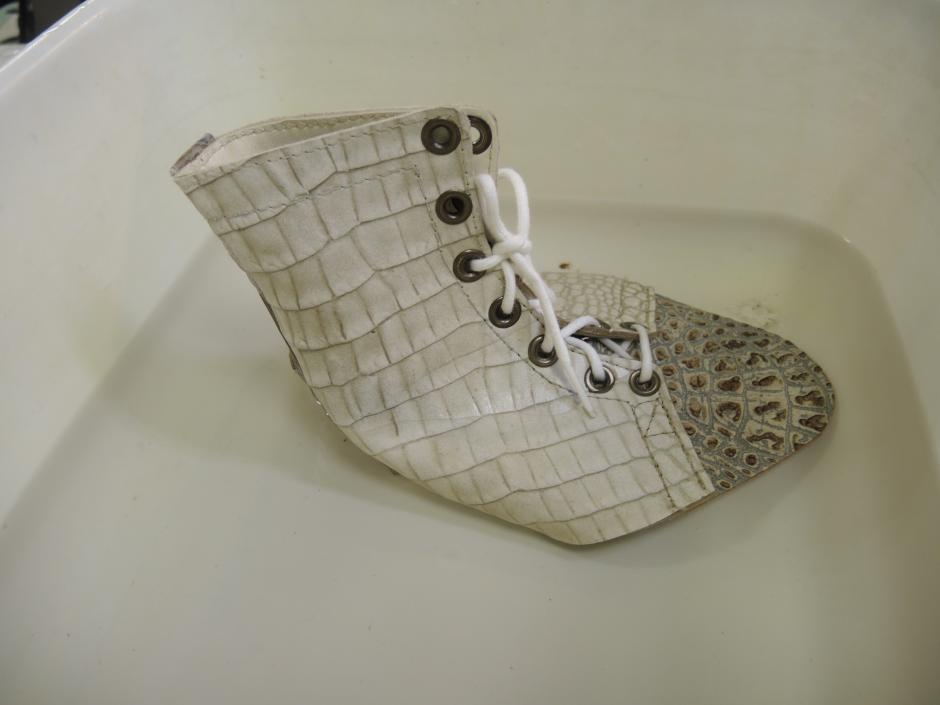 Pre-stiched boot soaks in water prior to being shaped on a last
