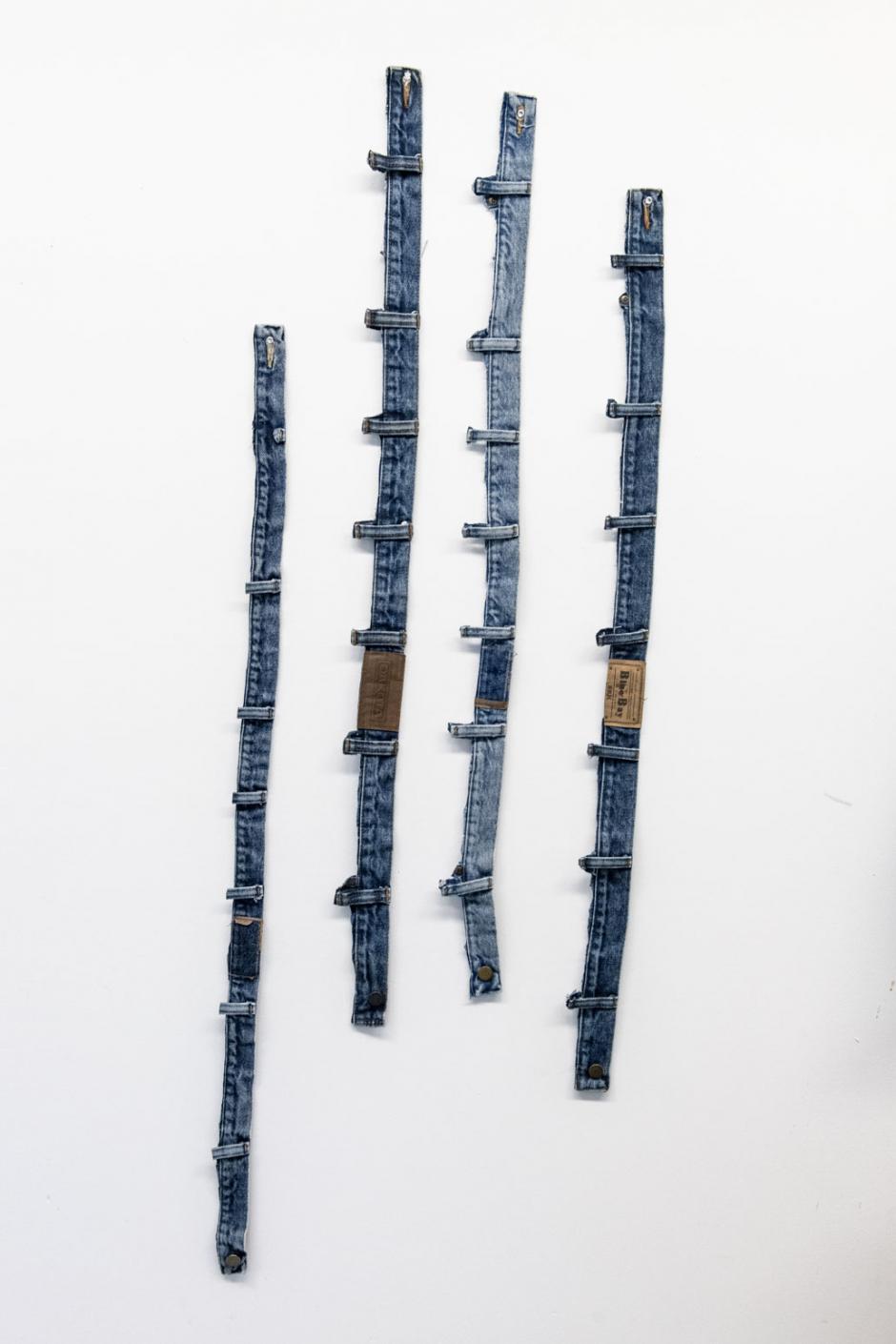 Denim artwork created by Stina Baudin exhibited on a white wall