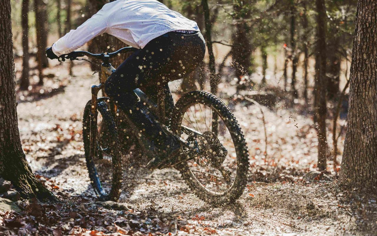 Man biking in forest