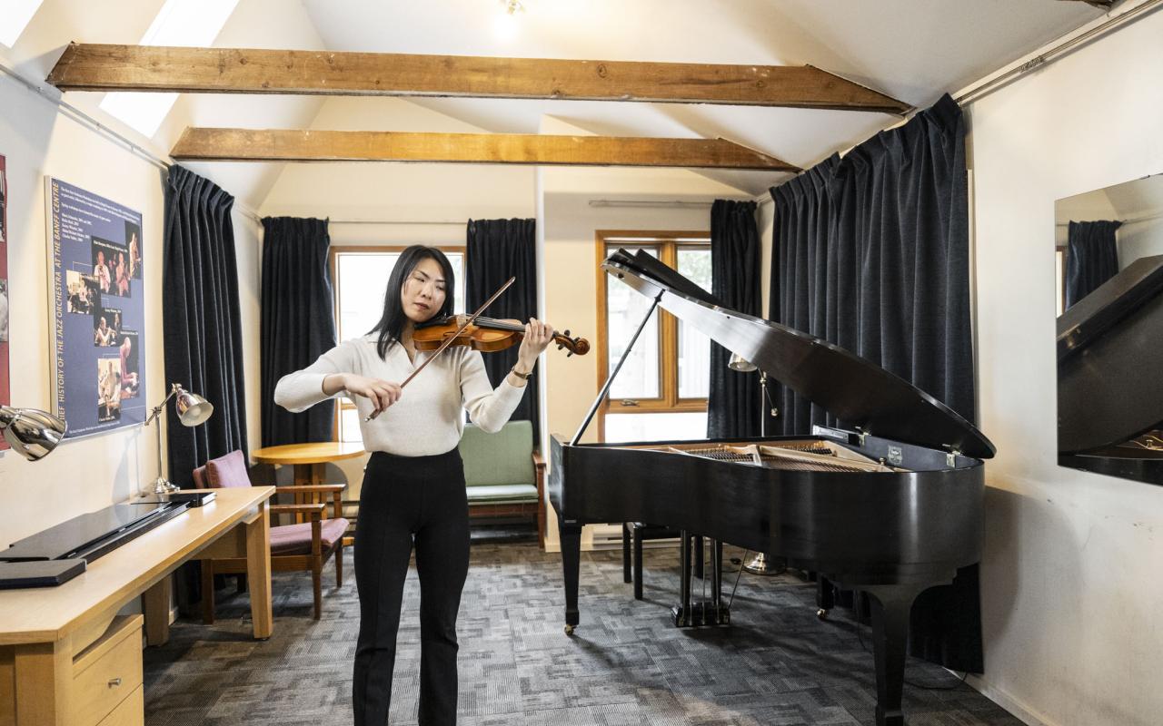 A violinist inside one of the Music Huts at Banff Centre. Photo Credit: Rita Taylor