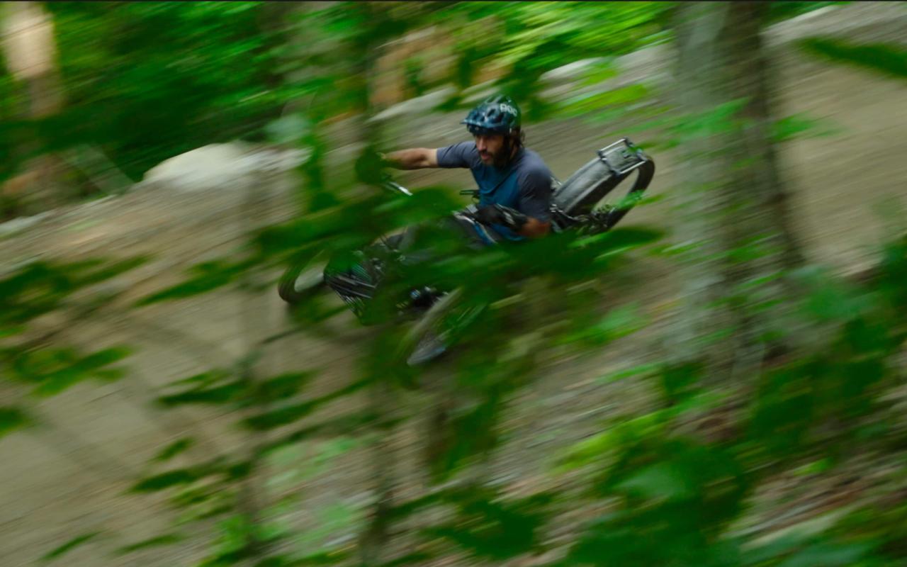Adaptative mountain biker riding in a forest