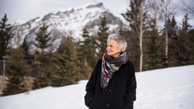 Banff Centre donor walking through campus with Cascade in the background.