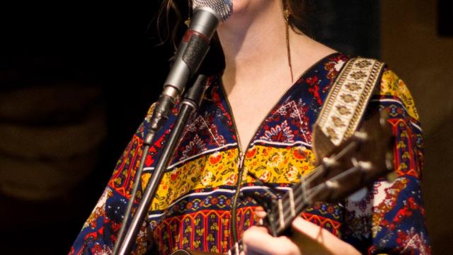 Heather Jean Jordan performing live with a guitar