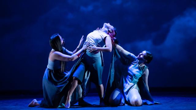 Three dancers perform on stage during the 2022 Intercultural Indigenous Dance Showcase