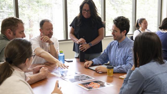 A group of people are engaged in a lively discussion in a classroom