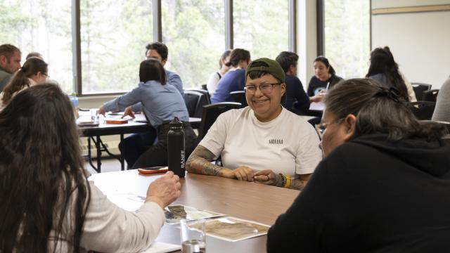 A group of people are engaged in a lively discussion in a classroom