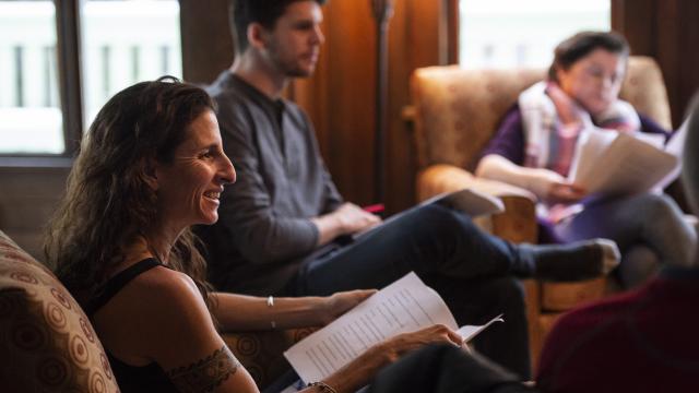 Writers sitting in a studio with open books.  