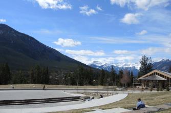 Phyllis Novak takes time to reflect looking at the Bourgeau mountain range. View from the amphitheatre at The Banff Centre
