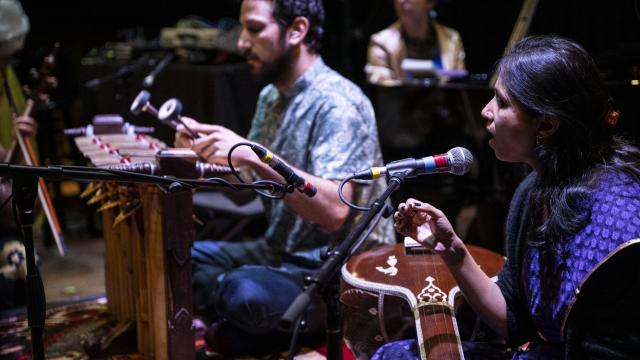 Two musicians playing instruments and singing