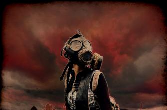 Woman standing in a field with dark, red sky and red tinted landscape. Woman wears gas mask, goggles and carries a large bag