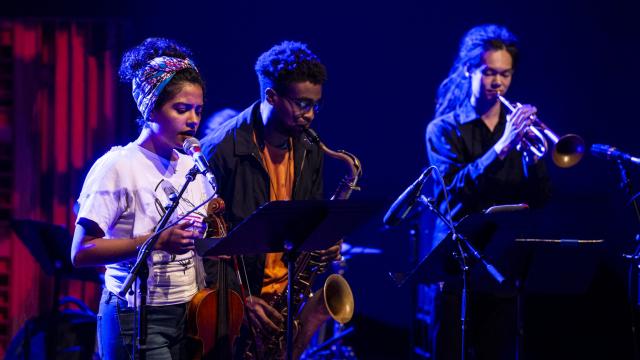 Three Musicians jam in darkened club