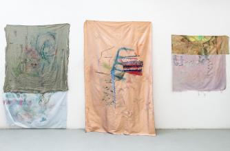 Three artworks by Maggie Crowley exhibited on the walls of her studio at Banff Centre