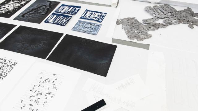 Artworks assembled on a table in Nura's studio at Banff Centre